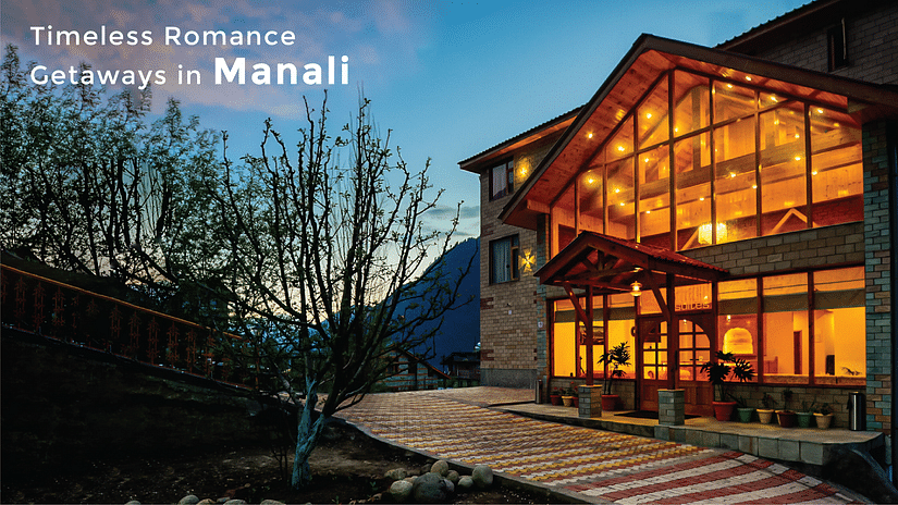 A facade of Clarks Inn Suites, Manali during sunset with the text saying 