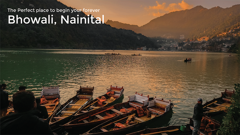 Boats on the deck of the lake in Nainital with mountains in the background as the dusk around the corner and the text says 'The perfect place to begin your forever - Bhowali, Nainital'