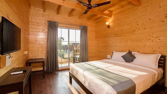 The wooden interiors of the bedroom - White Wood Resort, Morjim