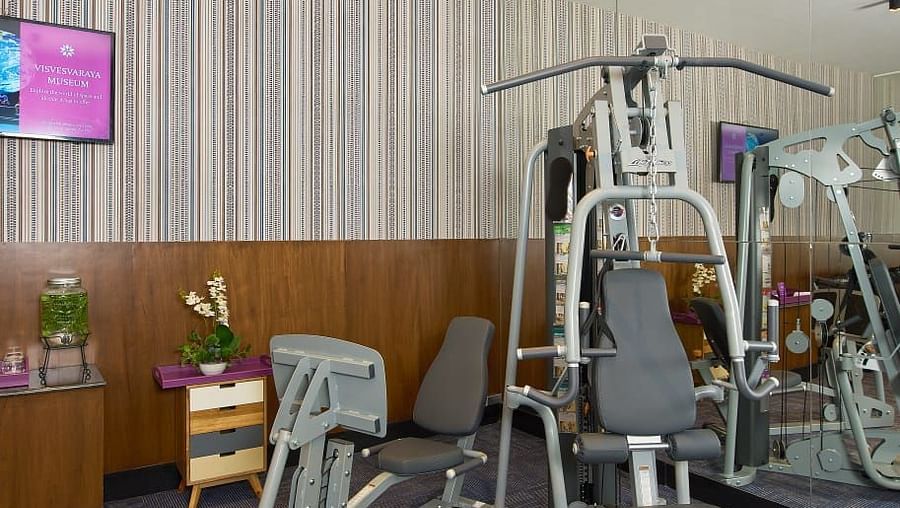 A variety of fitness machines arranged in an organised manner, with a well-maintained atmosphere, ideal for a full-body workout.