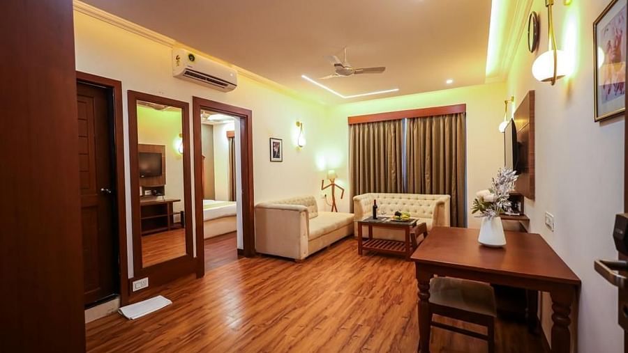 Image of a seatin room with dining table and sofas at Vagator Downtown, Goa 