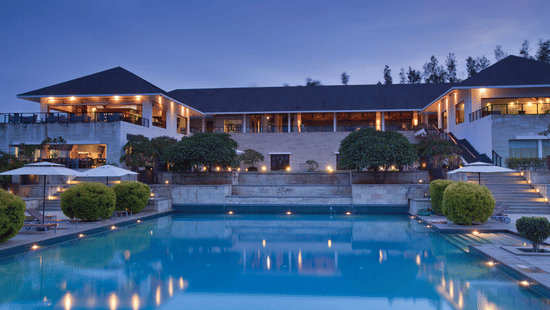 Swimming pool and exterior facade in late evening of The Serai, Chikmagalur.