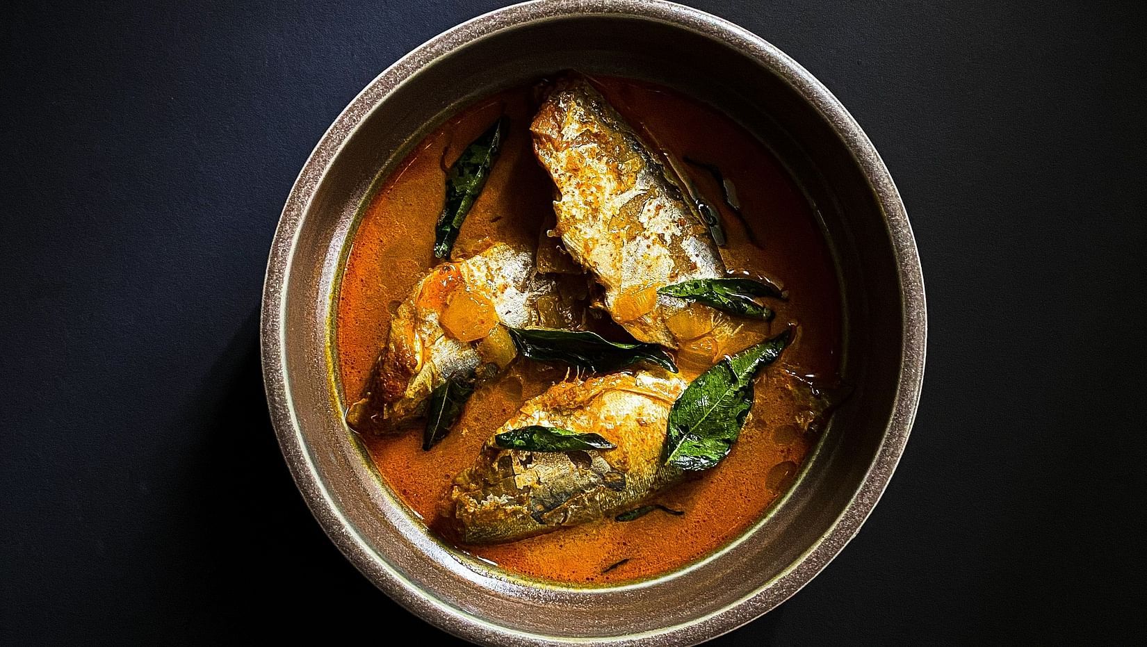 fish curry in a stainless bowl