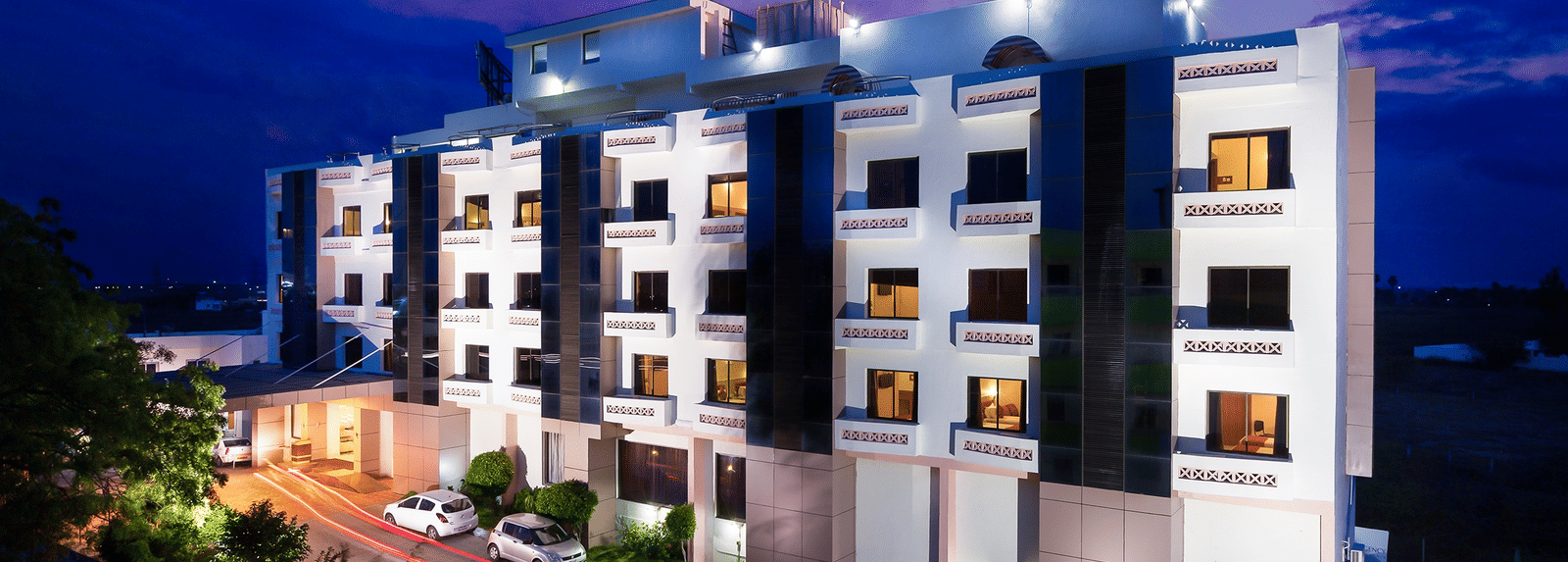 The exterior facade of a hotel building illuminated by warm lights - Regency Tuticorin by GRT Hotels, Best Hotel in Tuticorin