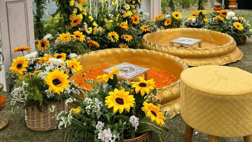 Decorative mirror setup surrounded by sunflowers and floral arrangements at The Manor Luxury Apartments, Shimla.
