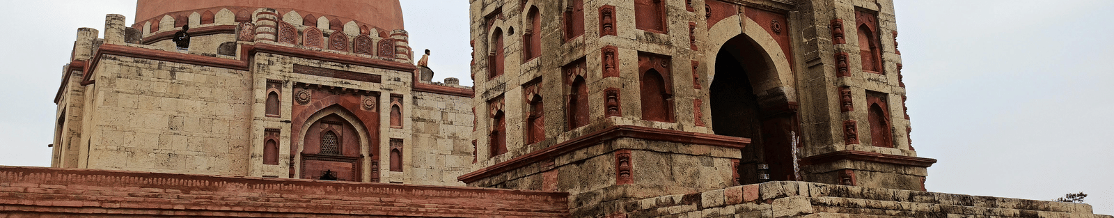 Historic red sandstone architecture with domes and arched entrances
