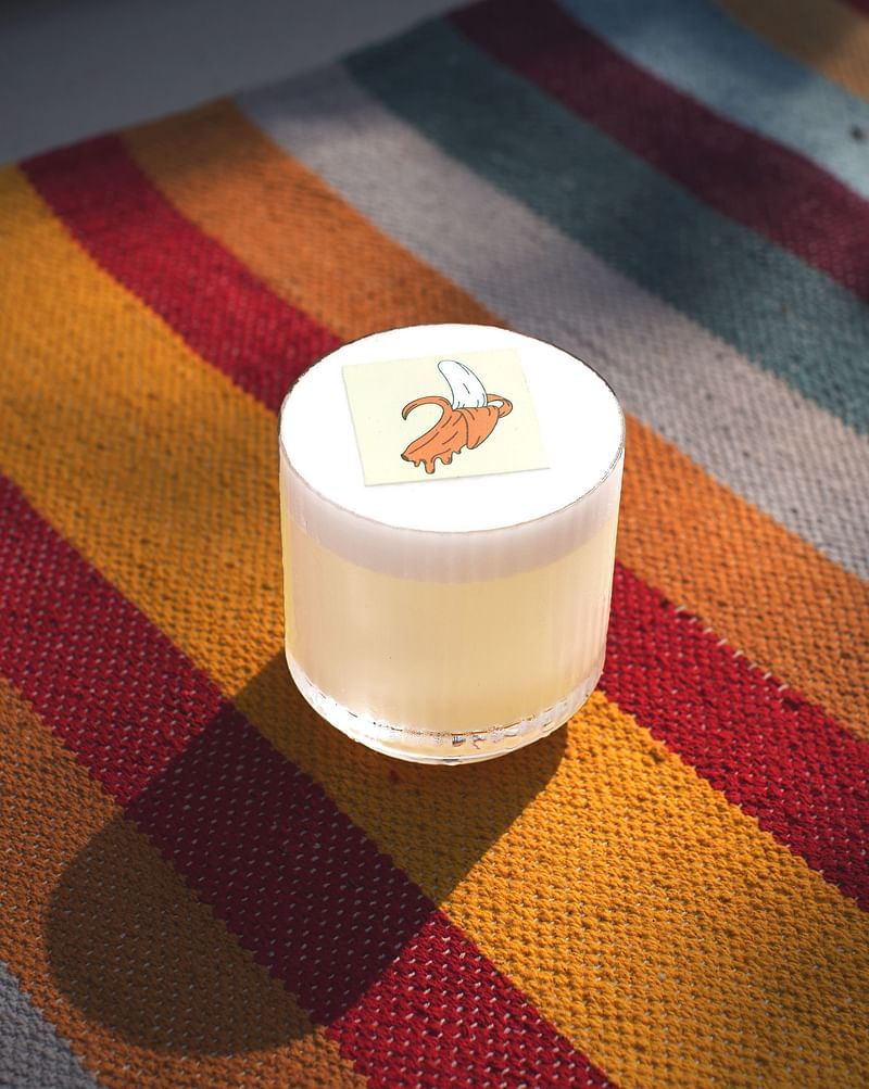 Banana drink in a small glass with sun shining on it