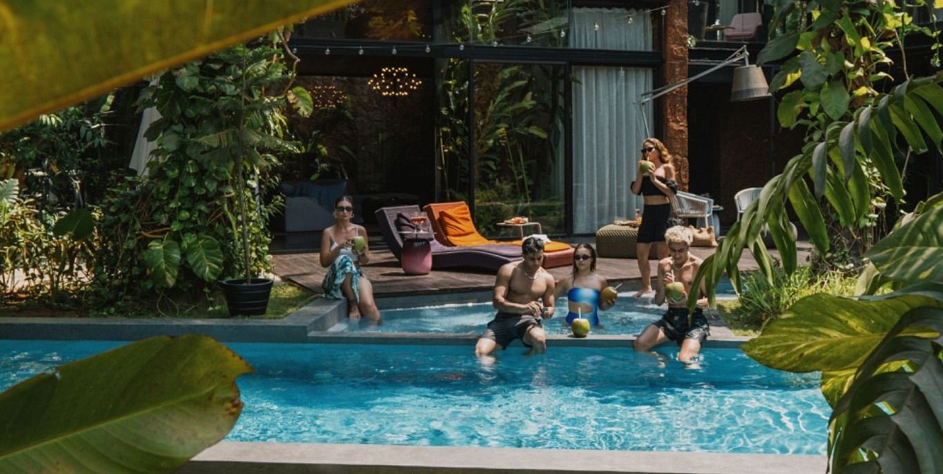 A partially visible swimming pool and greenery - Villa In Palms by V Escapes