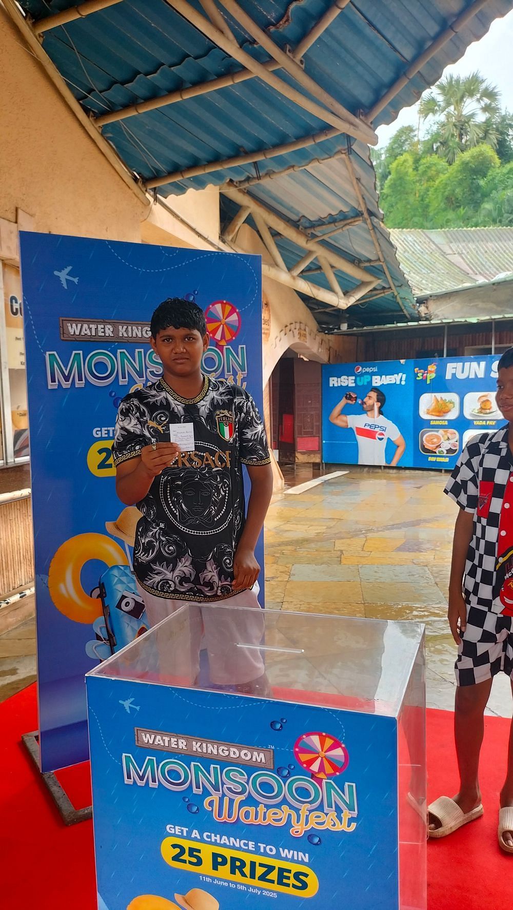 A colorful promotional banner for Water Kingdom Monsoon Waterfest showcasing the festive atmosphere and joyful winners celebrating their achievements.