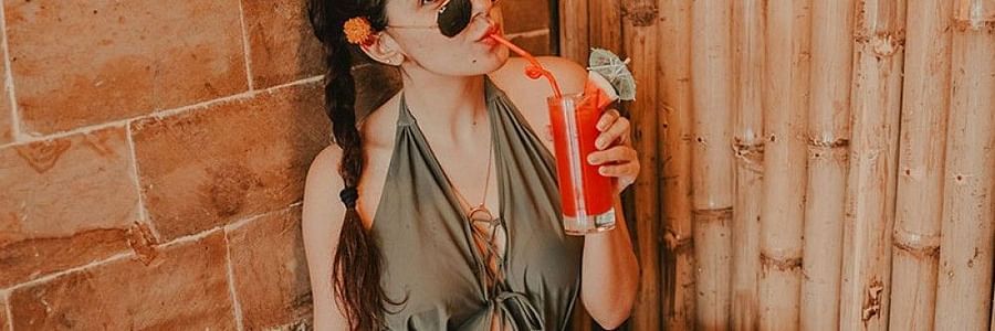a woman eating food  and drinking juices