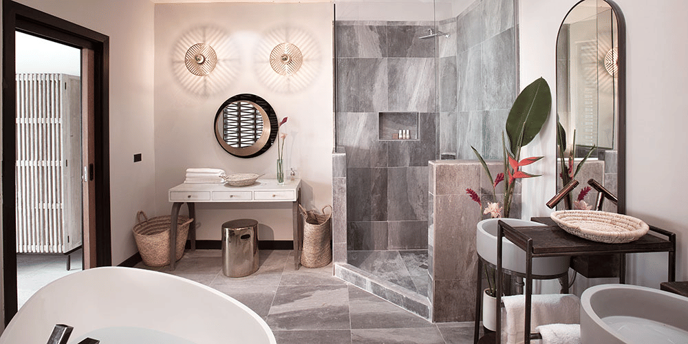 A modern bathroom with a double vanity featuring round mirrors and sleek fixtures.