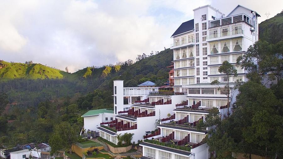 Facade view of Fragrant Nature Munnar, surrounded by majestic mountains