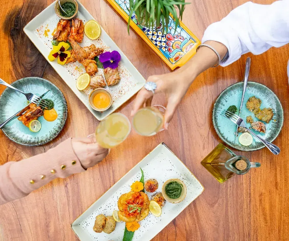 Flat-lay of assorted dishes and drinks served at Karma Chalets.