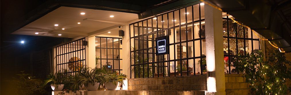 The exterior of the dining outlet lit up at night at Polo Resort Cherrapunjee.