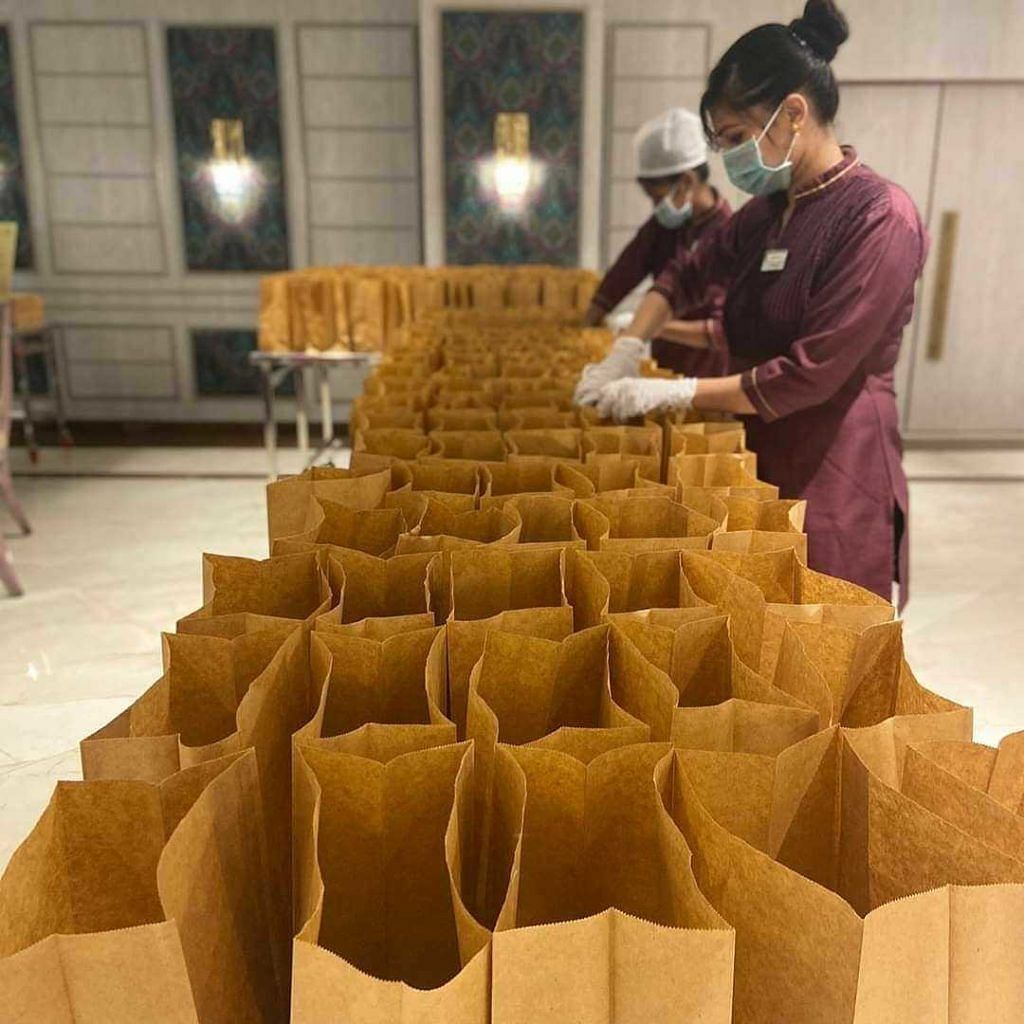 Image showing hotel staff arranging a bunch of paper bags.
