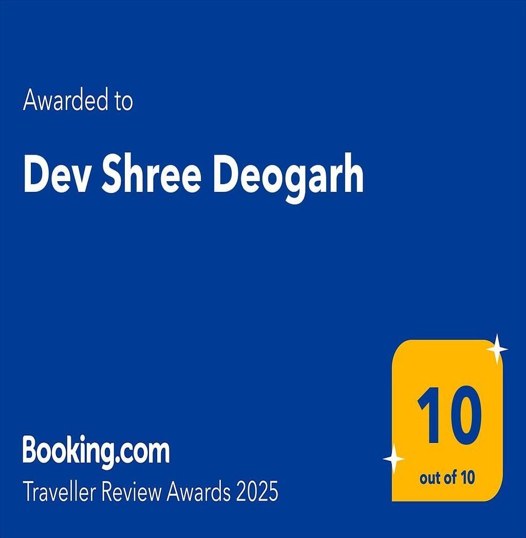 A Booking.com Traveller Review Awards 2025 badge, dark blue with a gold 10 out of 10 rating awarded to Dev Shree Deogarh.