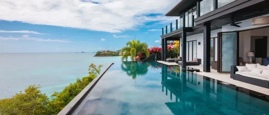 Infinity pool overlooking the Caribbean Sea beside a oceanfront villa at Tamarind Hills Resort and Villas, Antigua.