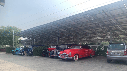 Many cars including vintage cars parked under a roof - Karma Lakelands.