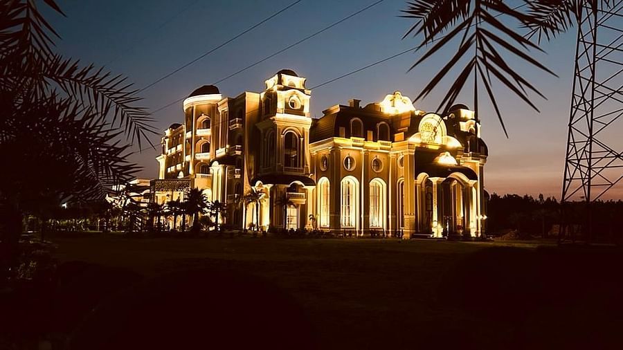 an image of the hotel facade taken during the evening with the hotel lit up with lights - Sarovar Portico, Saharanpur