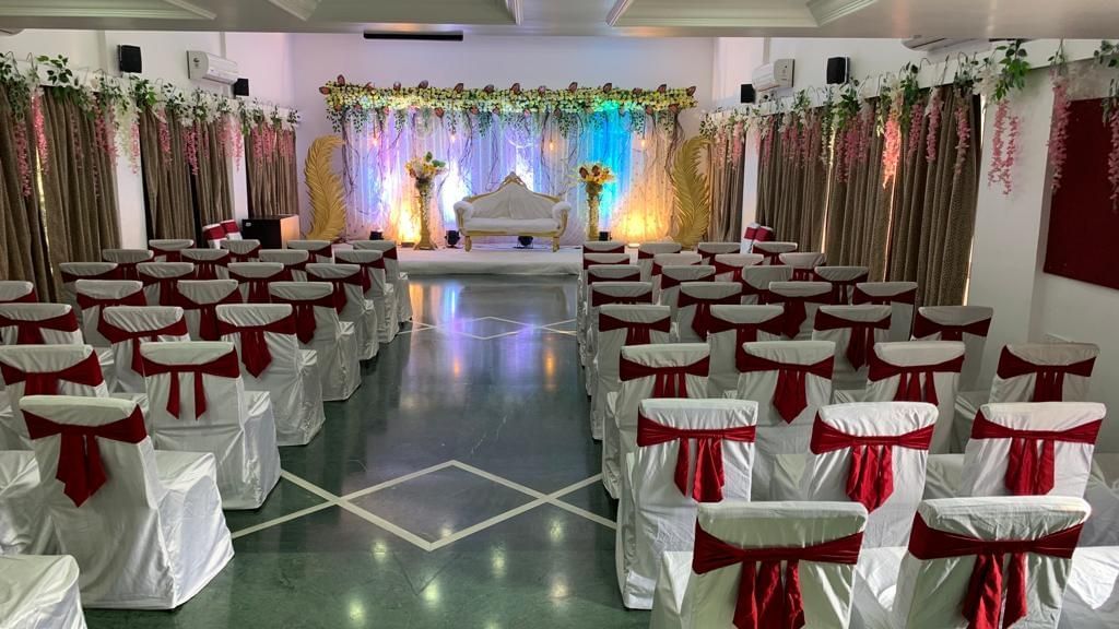 Event space at Mayur Retreat set up with decorated chairs and a view of the stage in the background.