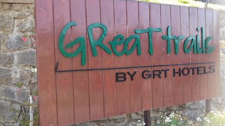 A wooden signboard of GReaT trails Kodaikanal by GRT Hotels