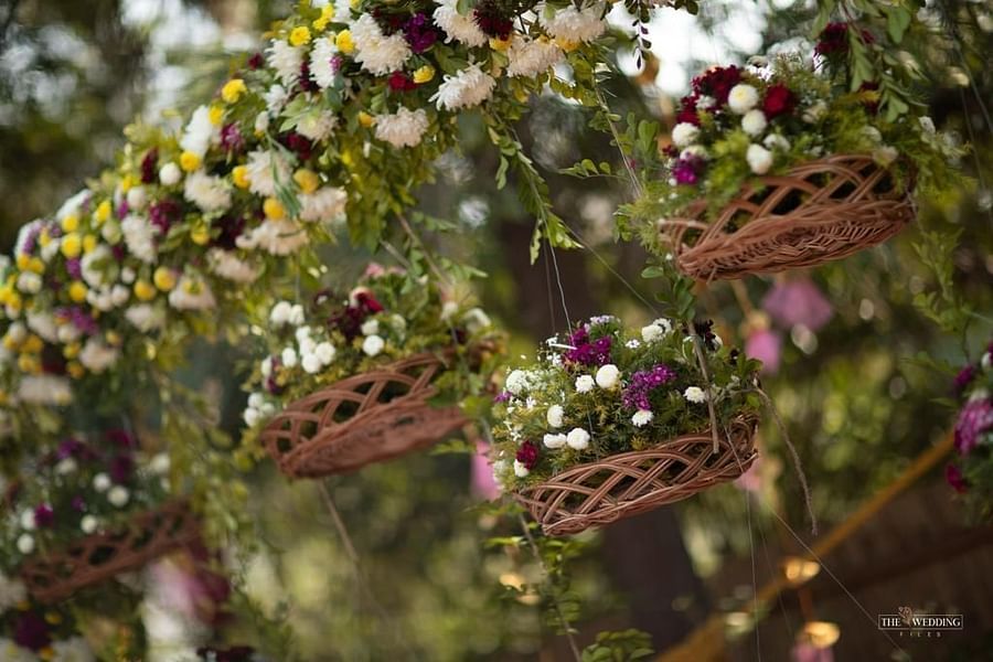 flower baskets hanging off a decorative arch