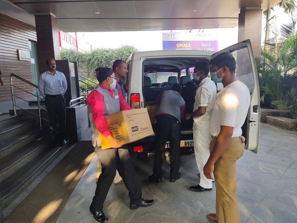 The staff loading the car with different supplies.