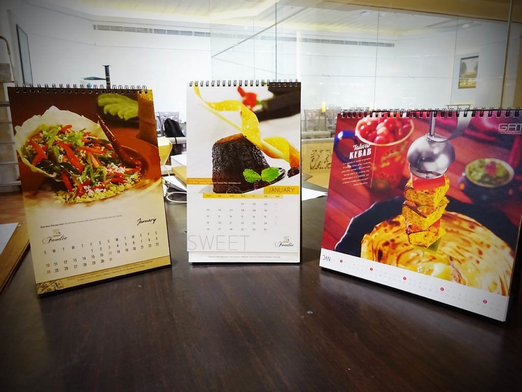 Calendars displayed with vibrant food photography and recipes.