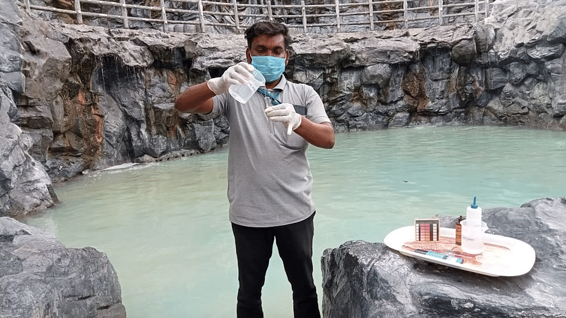 Staff member demonstrating poolside safety measures near the hot spring area at Black Thunder.