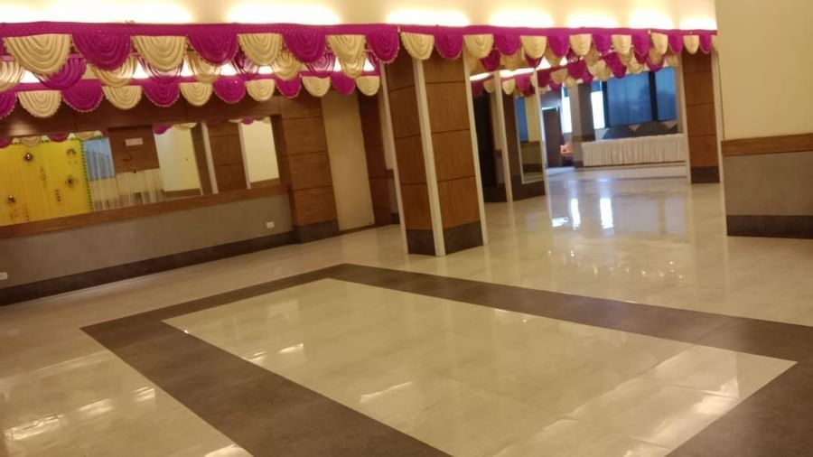 Banquet hall decorated with pink and white ceiling drapes at Max Hotel Prayagraj.