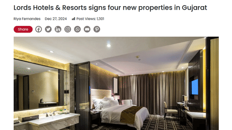 Modern hotel room with a large bed, elegant lighting, desk, and mirror, representing Lords Hotels & Resorts’ new property signings in Gujarat.