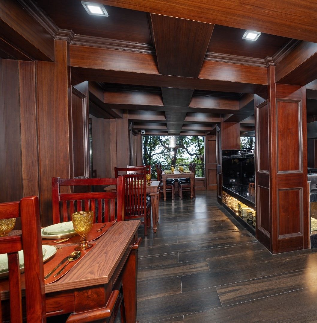 Image of the open air dining space featuring wooden furniture. 
