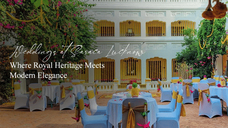 Vibrant courtyard with white columns, hanging greenery, and colourful dining tables arranged for a festive wedding setup at Saraca Lucknow.