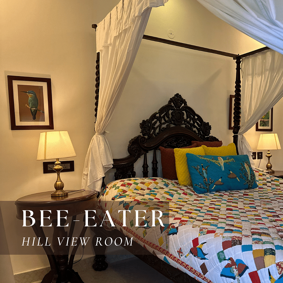 A bed with a patterned quilt and pillows - Bee Eater Hill View Room.
