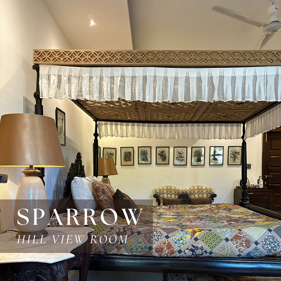 A four-poster bed with a quilt - Sparrow Hill View Room.