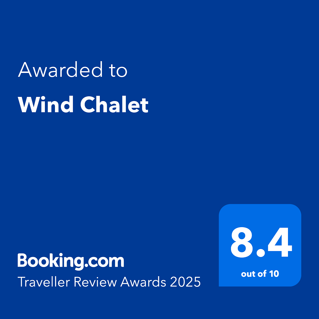 Awarded to Wind Chalet text with a Booking.com rating of 8.4.