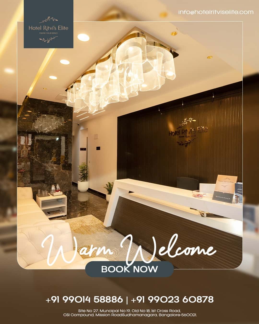 Reception and lounge seating at Hotel Ritvi's Elite beneath the cluster chandelier