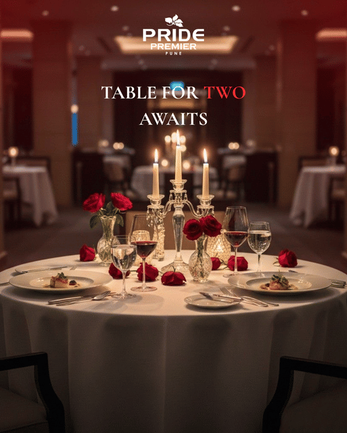 Creative featuring a dinner table with roses, desserts, candles, wine glasses and more at Pride Premier Pune.
