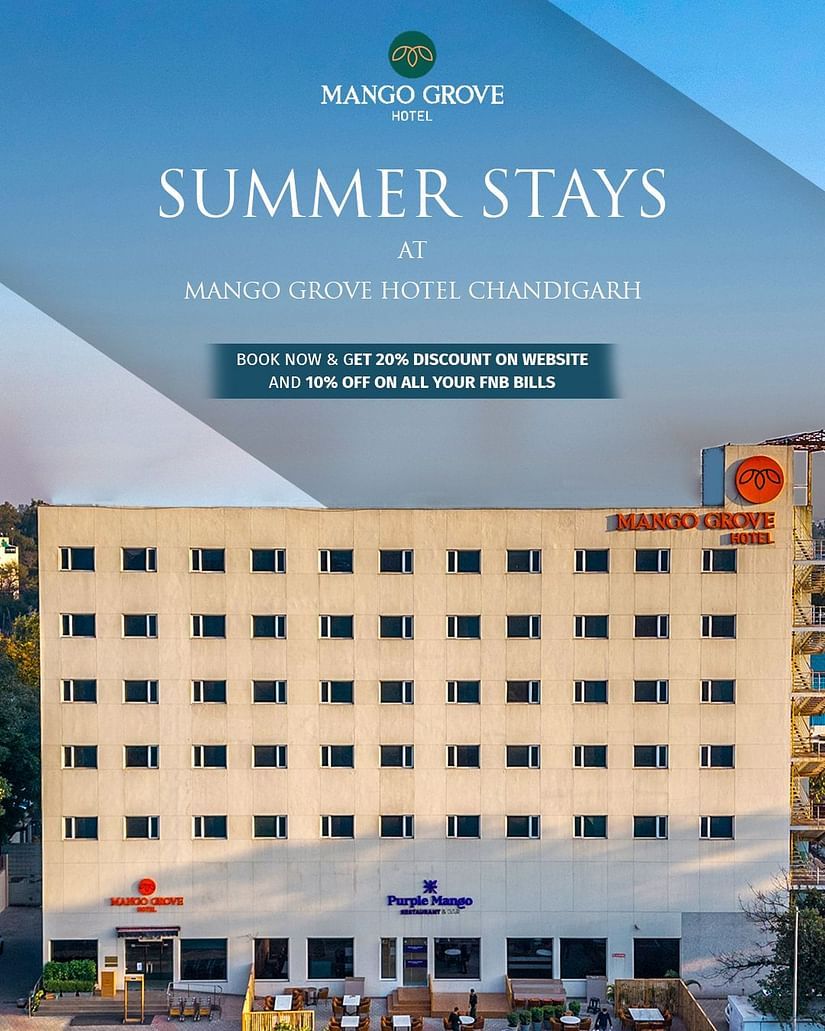 A promotional image for Mango Grove Hotel Chandigarh featuring its summer stay offer. The image showcases the hotel's exterior with a clear blue sky. The text highlights a special promotion: 20% discount on bookings made via the website and 10% off on all 