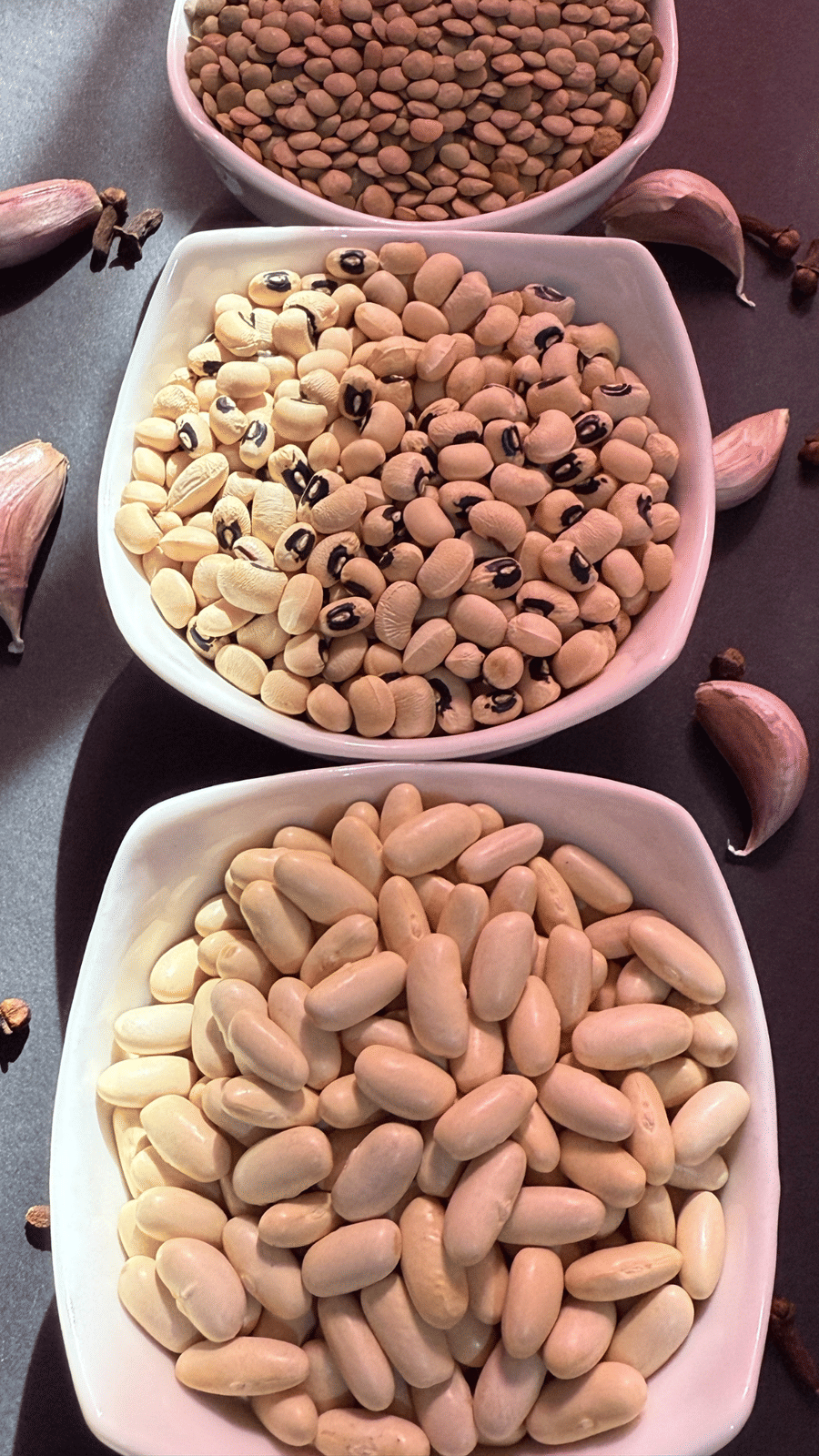 3 bowls containing different kinds of beans kept in a line
