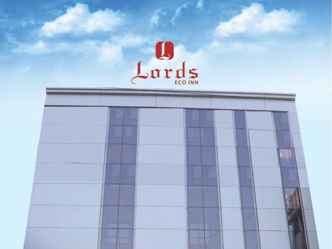 A digital rendering of a modern, red and white building with the 'Lords Inn' logo - Lords Hotels & Resorts