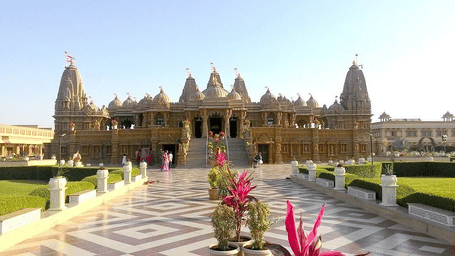 A large, intricate marble temple with a checkered path.