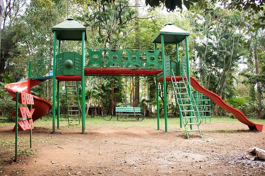 Kids Play Area - Sajan - a slide with green stairs and red body swirling down to touch the ground.
