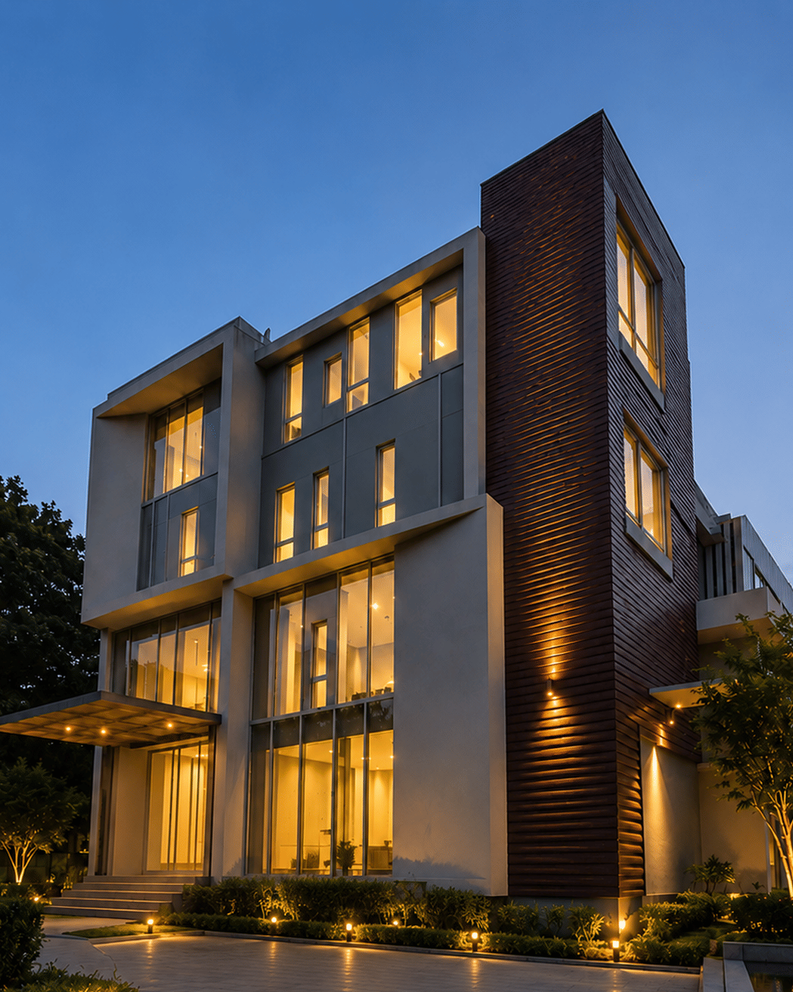 The illuminated multi-storey facade of Rossedale Suites & Hotel glowing against the evening sky on Avarampalayam Road in Peelamedu, Coimbatore