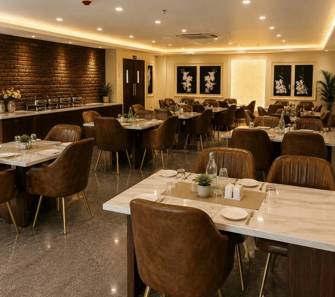 Indoor dining area of Amaya restaurant with set dining tables and brown chairs under warm ceiling spotlights.