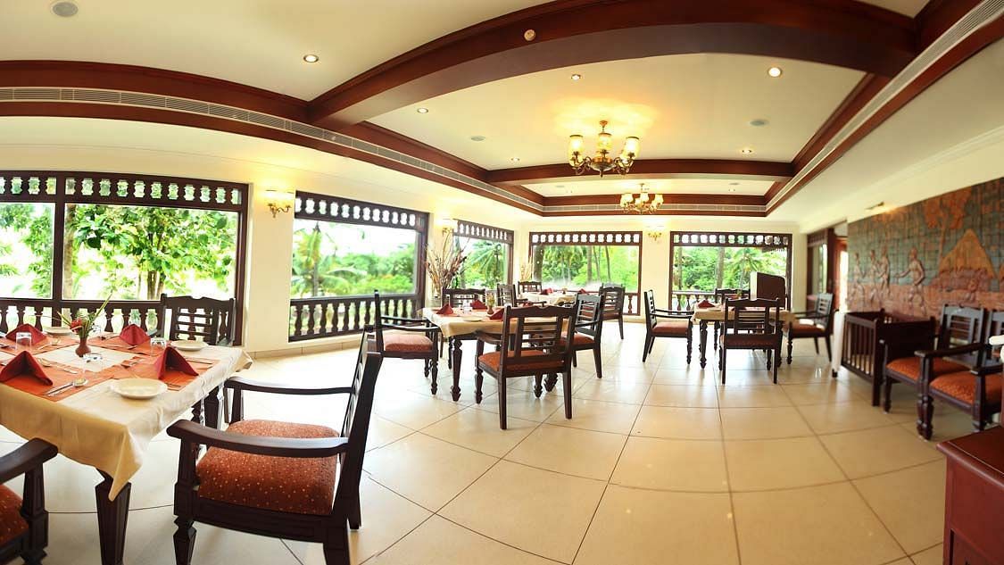 Dining area with tables laid with cutlery, prepared for the meal to be served