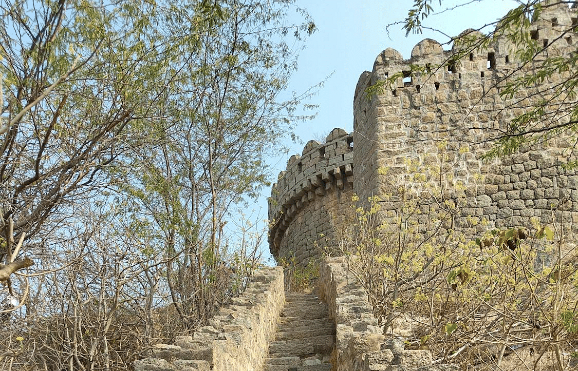 stone steps leading up to the top of a stone structure resembling an old fort