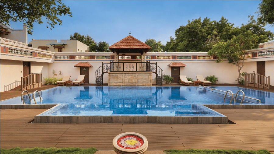 Banner for Amazing Chettinad offer featuring a luxury pool at Chidambara Vilas heritage resort with traditional architecture.