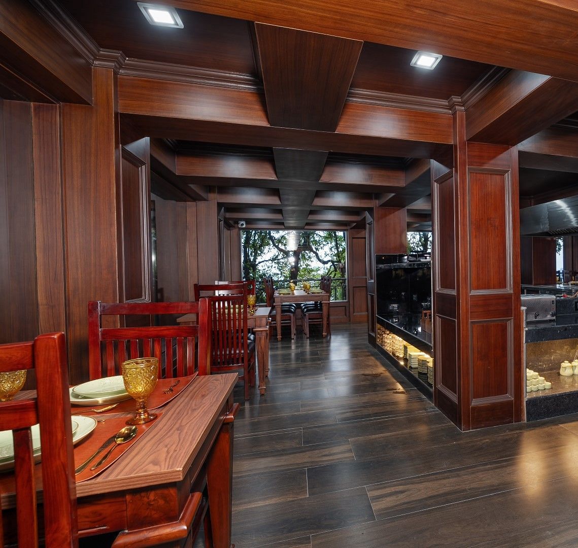 Image of the open air dining space featuring wooden furniture. 