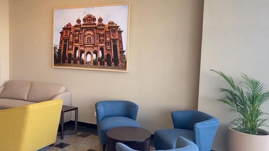 A view of the waiting area featuring cushioned furniture, a table in front, and a wall-mounted photo frame at  Urban Suites by BluSalzz, Jaipur.